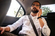 © kleberpicui - Business man using smartphone in back seat during urban commute