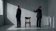 © yevhen89 - Man and woman standing separately, wearing dark suits, looking away from each other with a wooden chair in between. Concept of emotional distance and disagreement.