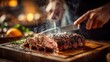 © rifai_art - Hands slicing a steaming, perfectly cooked, herb-crusted roast beef on a wooden board