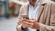 © Denis Yevtekhov - Faceless cool man checking cellphone, mobile device usage, smartphone activity, technology interaction, casual phone checking, defocused person with mobile, with copy space