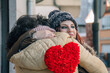 © tetxu - A couple in love embracing with a red heart in their hands, a symbol of love and the celebration of Valentine's Day.
