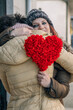 © tetxu - A couple in love embracing with a red heart in their hands, a symbol of love and the celebration of Valentine's Day.