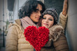 © tetxu - Couple in love holding red heart in their hands symbol of love and valentine's day celebration