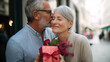 © Kateryna - Faceless happy senior couple hugging and kissing on valentine's day holding gift and flower bouquet elderly romance mature love celebration generational affection special