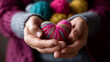 © Kateryna - Mixed colors yarn heart on giving hands closeup colorful handmade creation healthy heart donation concept healthcare symbolism valentine romance love forever theme with copy