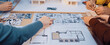 © InfiniteFlow - A dynamic group engaged in architectural design shares ideas and explores models and drawings, highlighting collaboration in a creative workspace filled with inspiration. SACTR