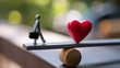 © Laura - Stick figure on seesaw with briefcase and heart, symbolizing delicate balance between work and life, professional-personal equilibrium, career-wellness harmony, conceptual balance