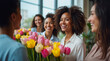 © Krystyna - Women Receiving Flowers at Office on Women Day. Corporate Women Day Appreciation Moment. Happy Female Employees Spring Celebration