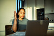 © Marko Geber - Young woman frustrated on video call at home kitchen