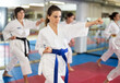 © JackF - Group of women in kimonos train karate techniques in studio