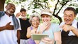 © Rawpixel.com - Group of diverse seniors laughing together outdoors, enjoying a moment. Seniors sharing joy, looking at phone. Happy seniors, diverse and joyful in the park. Group of diverse senior people in park.