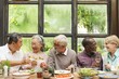 © Rawpixel.com - Group of diverse seniors enjoying a meal together, sharing laughter and wine. Elderly friends, diverse gathering, joyful meal, happy seniors. Senior friends celebrating with wine for lunch.