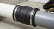 © DreamLab - Hand tightening hose clamp on rubber pipe coupling connector