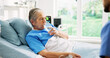 © MagicDavid25/peopleimages.com - Senior woman, drinking water and doctor by hospital bed, rest and recovery with hydration for wellness. Elderly person, medical worker and glass with liquid, detox and support for healing at clinic