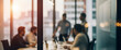 © birulaut - Blurred business meeting through glass with bright sunset light flare creating modern corporate atmosphere with soft reflections, dynamic silhouettes, warm tones, and professional teamwork mood