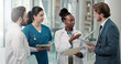© SparkPix/peopleimages.com - Businessman, doctors or meeting with folder in clinic for medical admin, patient system or planning. People, healthcare team and HR manager with tech for insurance claim, staff policy and compliance