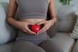 © crizzystudio - Woman holding red heart showing body care and health