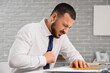 © Pixel-Shot - Young businessman feeling unwell at table in office