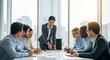 © jakir - Confident businesswoman presenting data to diverse team in modern office