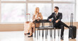 © Pixel-Shot - Young couple waiting for their flight at the airport