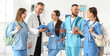 © Pixel-Shot - Group of medical interns and doctor with clipboard in clinic
