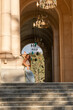 © svetograph - Woman, Stairs, Building - A woman poses at the top of a set of stone stairs inside a building with arched entryways.