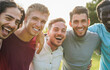 © DisobeyArt - Happy male friends having fun together outdoor - Group of multiracial men hugging each other at city park - Friendship and lifestyle concept - Main focus on blond man face