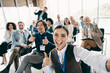 © deagreez - Group of diverse professionals posing together at a collaborative training in a conference hall to showcase teamwork