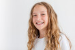 © Tatyana Gladskih - Portrait of happy girl 12 years old with long curly hair in white T-shirt on gray background, studio shot