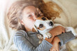 © Tatyana Gladskih - Cute happy child Girl plays with her Dog at home.