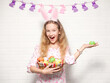 © Tatyana Gladskih - Child girl holding basket with colorfull Easter eggs, looking at camera