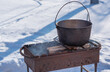 © T.Den_Team - Outdoor winter cooking, man preparing food in cauldron