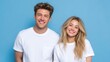 © mila103 - Smiling young caucasian couple in white t-shirts against blue background.