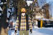 © anatoliycherkas - Man enjoying winter sunlight in snowy park, feeling warmth and peaceful moments outdoors during cold season