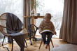 © Tomsickova - Cute toddler child in a little fancy wooden cottage, reading a book, drinking tea