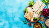 Vibrant spread of traditional matzah bread, fresh mint, sweet cherries, crunchy nuts, and savory olives, artfully arranged on bright blue textured background, ideal for festive gatherings or healthy M