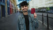 © Krakenimages.com - Man holding turkish passport smiling on urban street outdoors in daylight showcasing international travel.
