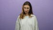 © Krakenimages.com - Woman frowning in front of an isolated purple background wearing a white sweatshirt, expressing displeasure with a serious expression in a studio setting.