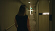 © Krakenimages.com - Woman walking down hotel corridor with bare shoulders visible in building hallway; anticipation solo journey.