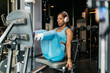 © ADDICTIVE STOCK - Woman training in hotel gym using leg press machine