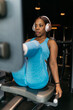 © ADDICTIVE STOCK - Hotel gym workout with exercise machine and headphones