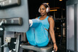 © ADDICTIVE STOCK - Hotel gym workout with exercise machine and headphones