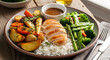 © Ton_Studio - Healthy chicken breast meal with fluffy rice, colorful roasted vegetables, fresh greens, and savory gravy for a complete balanced dinner