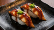 © Sabbir9003 - Delicious unagi nigiri sushi on a black plate