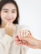© Bangkok Click Studio - Close up holding hands asian young loving couple showing rings wedding love together relationship good time moment commitment sweet happy beautiful jewelry romantic marriage celebrating Valentine Day
