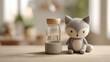 © OlgaKon - Cute gray fox plush toy next to a glass bottle on wooden table