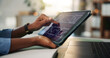 © WesJVR/peopleimages.com - Hands, tablet screen and graphs at office for trading, stats or laptop for stock market analysis. Person, broker or investor with tech, ux and click for chart, review or fintech app at finance agency