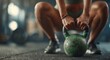 © Julia - A green kettlebell is lifted by a woman, revealing her determination and power