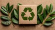 © Julia - A shallow‑depth view shows a cardboard‑cut recycling symbol over a green leafy background