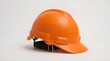 © Valen - An orange safety helmet is placed against a clean white background. The helmet is made of durable plastic with a smooth, glossy finish designed for high visibility.